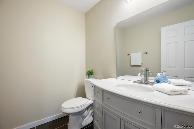 595 Wintery Cir, Colorado Springs, CO 80919 - bathroom featuring vanity, toilet, tile patterned floors, and baseboards