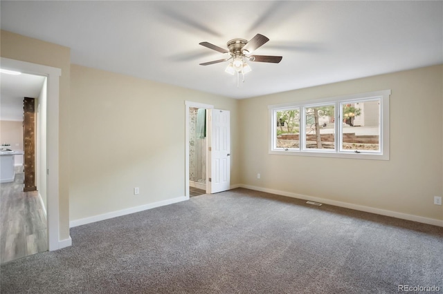 595 Wintery Cir, Colorado Springs, CO 80919 - unfurnished bedroom with carpet, baseboards, connected bathroom, and a ceiling fan