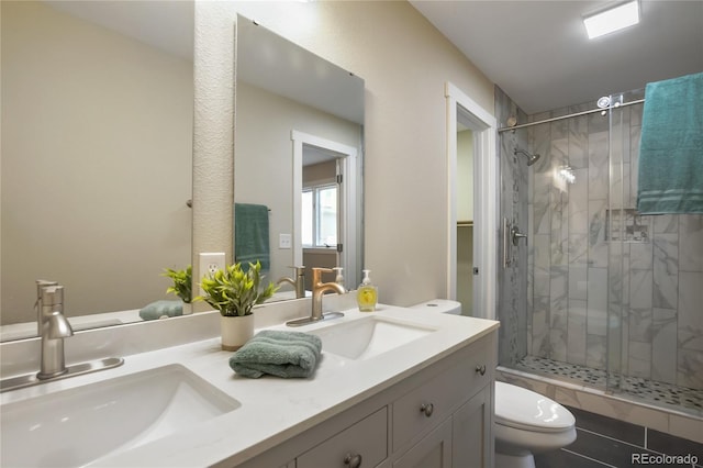 595 Wintery Cir, Colorado Springs, CO 80919 - bathroom with a stall shower, toilet, and double vanity