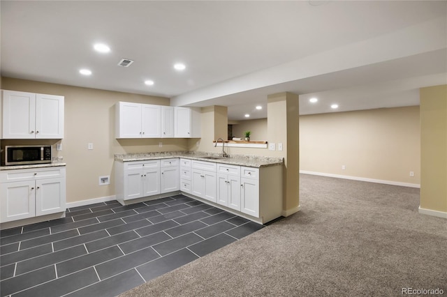 595 Wintery Cir, Colorado Springs, CO 80919 - kitchen featuring stainless steel microwave, baseboards, white cabinets, recessed lighting, and a sink