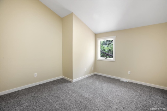 595 Wintery Cir, Colorado Springs, CO 80919 - unfurnished room with lofted ceiling, dark colored carpet, and baseboards