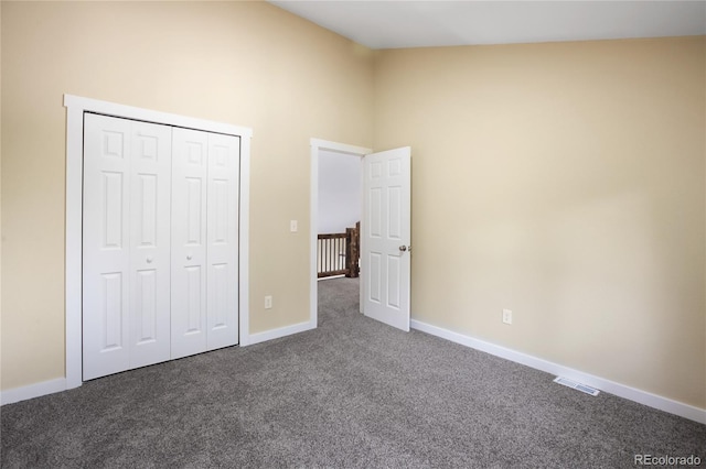 595 Wintery Cir, Colorado Springs, CO 80919 - unfurnished bedroom with dark colored carpet, baseboards, high vaulted ceiling, and a closet