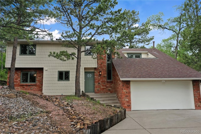 595 Wintery Cir, Colorado Springs, CO 80919 - view of front of house featuring driveway, an attached garage, roof with shingles, and brick siding