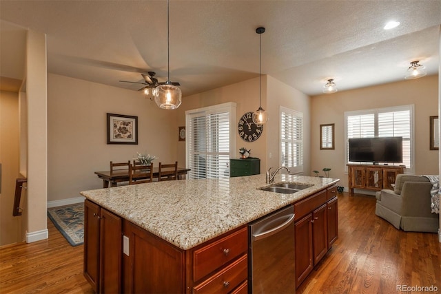9165 Kornbrust Dr, Lone Tree, CO 80124 - kitchen with a sink, stainless steel dishwasher, open floor plan, and light wood-type flooring