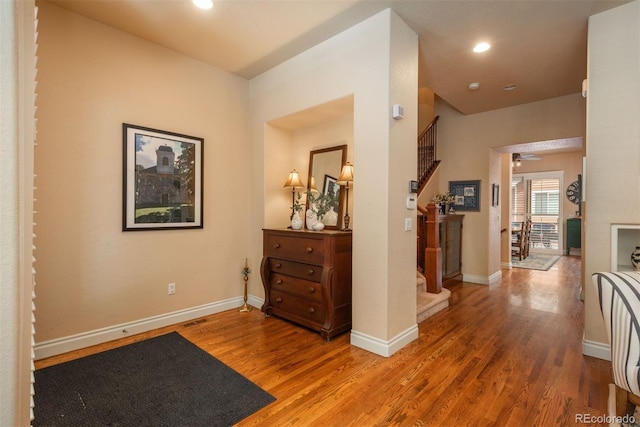 9165 Kornbrust Dr, Lone Tree, CO 80124 - hallway with stairs, wood finished floors, baseboards, and recessed lighting