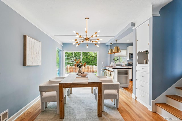 dining space featuring a chandelier, light wood finished floors, baseboards, stairway, and recessed lighting