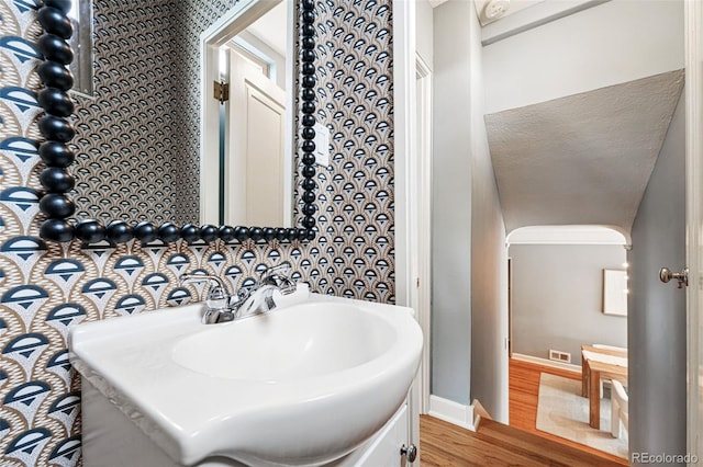 bathroom with wood finished floors, baseboards, and vanity