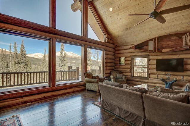 1198 Kootchie Kootchie Rd, Alma, CO 80420 - living room with a mountain view, dark hardwood / wood-style floors, high vaulted ceiling, rustic walls, and ceiling fan