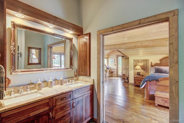 1198 Kootchie Kootchie Rd, Alma, CO 80420 - bathroom featuring lofted ceiling, double sink vanity, and hardwood / wood-style floors