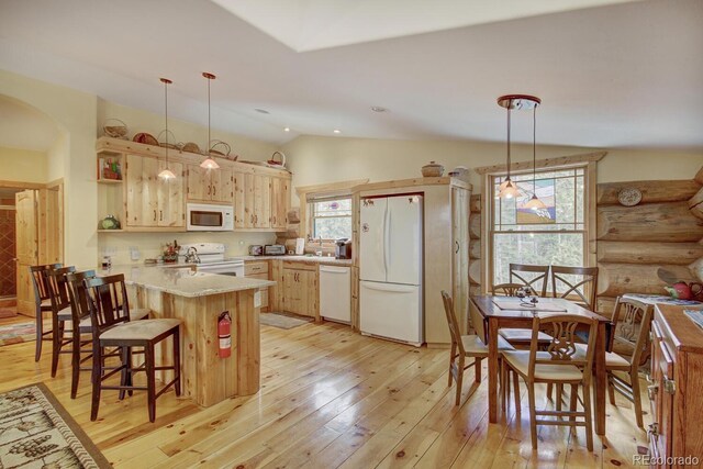 1198 Kootchie Kootchie Rd, Alma, CO 80420 - kitchen featuring hanging light fixtures, lofted ceiling, light wood-type flooring, white appliances, and kitchen peninsula