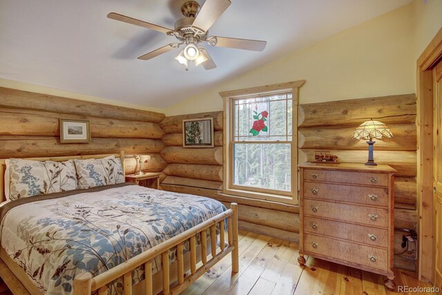 1198 Kootchie Kootchie Rd, Alma, CO 80420 - bedroom with ceiling fan, light hardwood / wood-style floors, log walls, and lofted ceiling