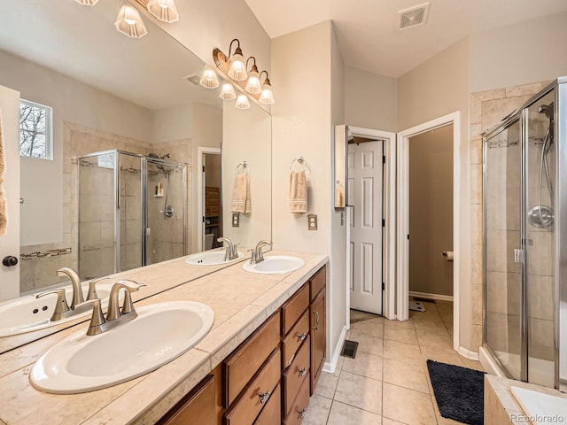 bathroom featuring tile patterned floors, an enclosed shower, and vanity