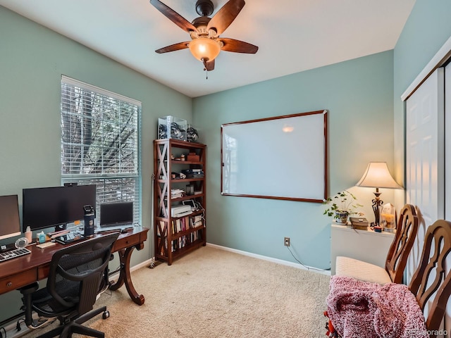 carpeted home office with ceiling fan