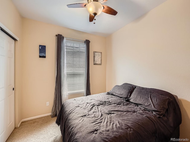 carpeted bedroom featuring ceiling fan and a closet