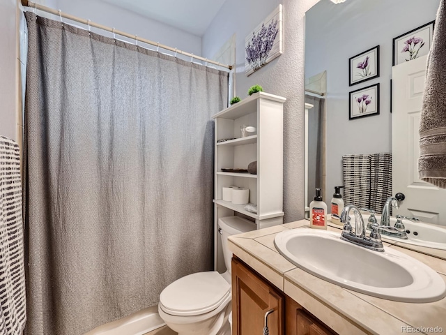 bathroom with a shower with curtain, vanity, and toilet