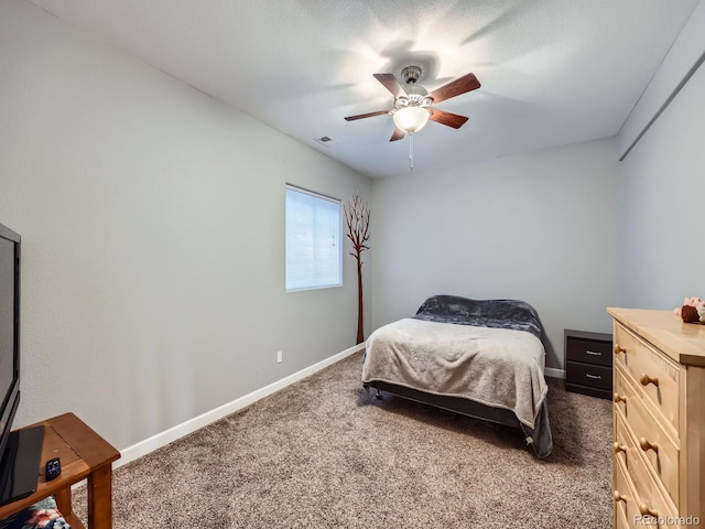 bedroom with ceiling fan and dark carpet