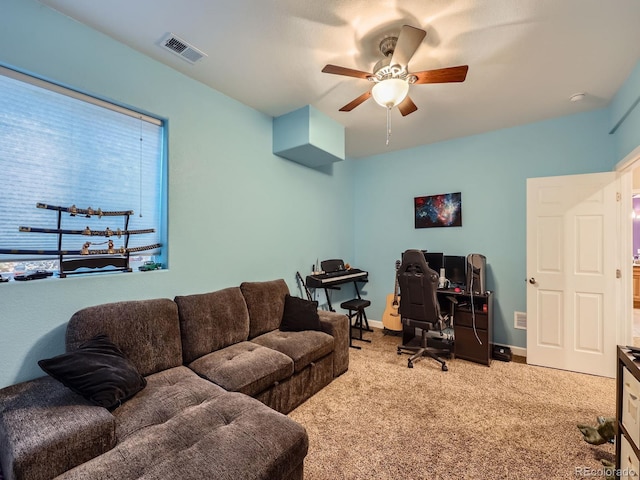 carpeted office space with ceiling fan