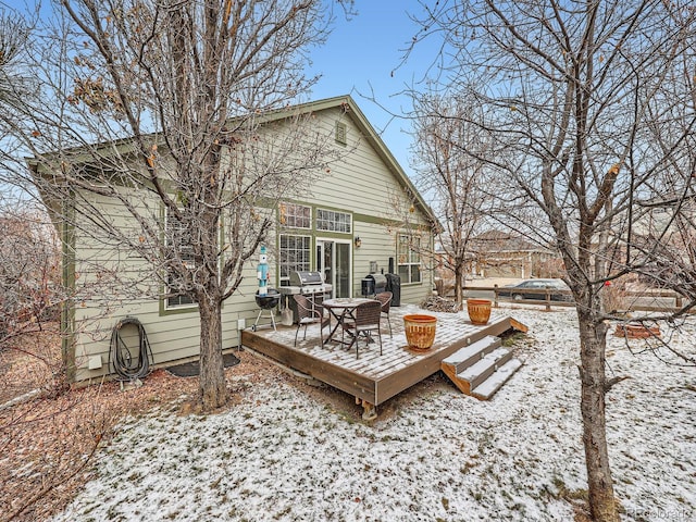 snow covered deck featuring area for grilling