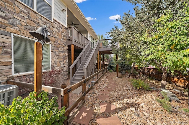 view of home's exterior featuring central air condition unit and ceiling fan