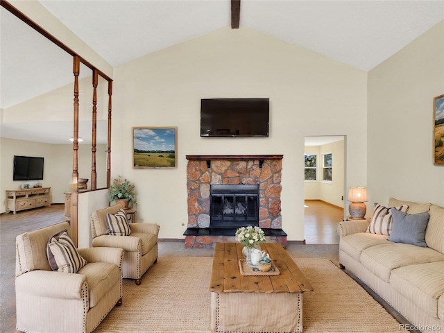 living area with a stone fireplace, beam ceiling, baseboards, and high vaulted ceiling