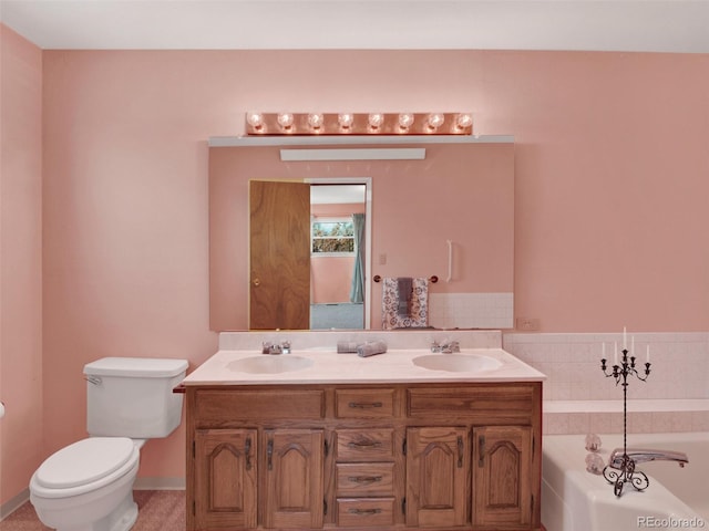 bathroom featuring a garden tub, toilet, double vanity, and a sink