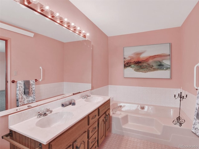 bathroom with double vanity, a garden tub, and a sink