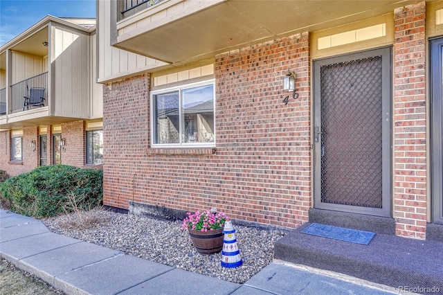 property entrance featuring brick siding and board and batten siding