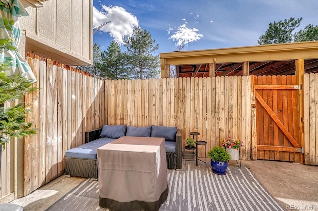 view of patio featuring an outdoor living space and fence