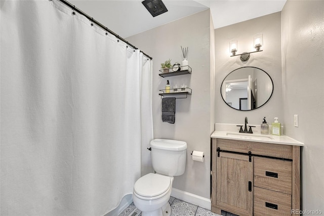 bathroom featuring baseboards, toilet, vanity, and tile patterned floors