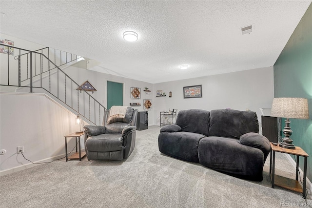 living area featuring carpet flooring, a textured ceiling, visible vents, baseboards, and stairway