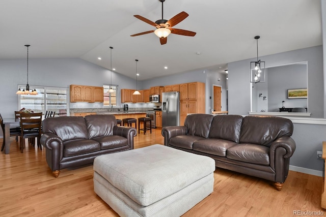 living room with baseboards, high vaulted ceiling, a ceiling fan, and light wood-style floors