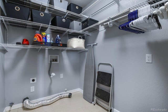 laundry area with electric dryer hookup, baseboards, gas dryer hookup, hookup for a washing machine, and laundry area