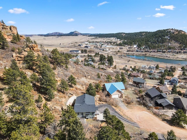 drone / aerial view with a water and mountain view