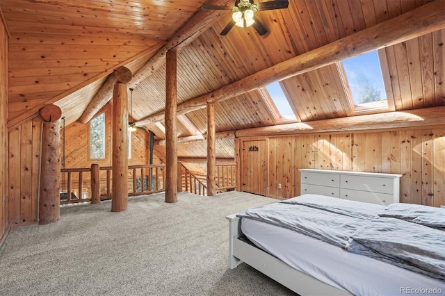 bedroom featuring vaulted ceiling with skylight, wooden ceiling, wood walls, and carpet