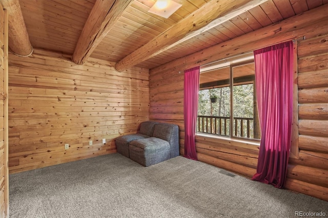unfurnished room featuring log walls, visible vents, beam ceiling, carpet, and wood ceiling