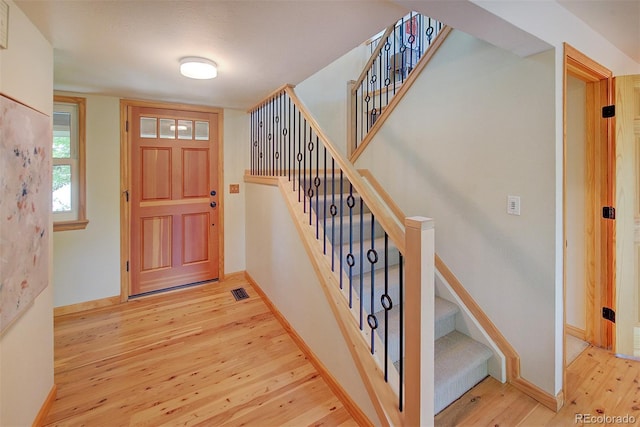 3966 Bosque Ct, Boulder, CO 80301 - foyer with light wood finished floors, stairs, and baseboards