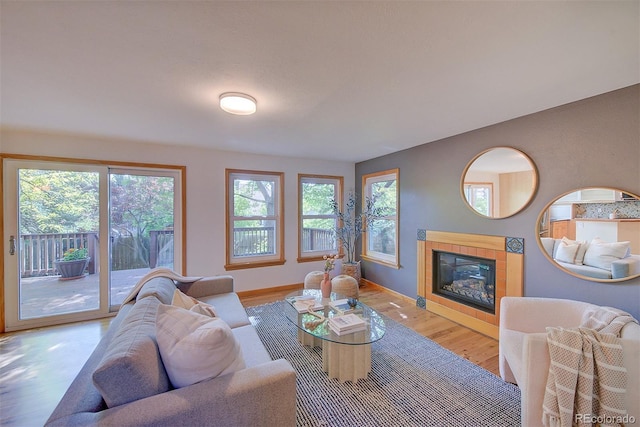 3966 Bosque Ct, Boulder, CO 80301 - living room featuring a tile fireplace, wood finished floors, and baseboards