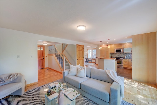 3966 Bosque Ct, Boulder, CO 80301 - living room featuring stairs, light wood finished floors, recessed lighting, and baseboards