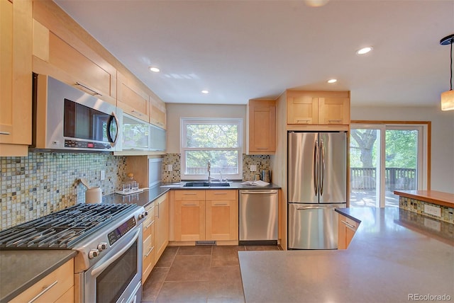 3966 Bosque Ct, Boulder, CO 80301 - kitchen with appliances with stainless steel finishes, light brown cabinetry, a sink, tasteful backsplash, and recessed lighting