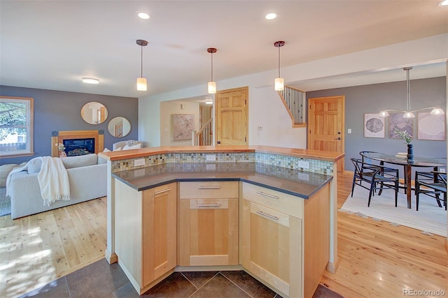 3966 Bosque Ct, Boulder, CO 80301 - kitchen featuring dark countertops, light brown cabinets, open floor plan, dark wood finished floors, and recessed lighting