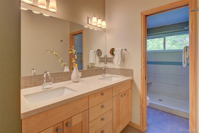 3966 Bosque Ct, Boulder, CO 80301 - bathroom with double vanity, toilet, backsplash, and tile patterned floors
