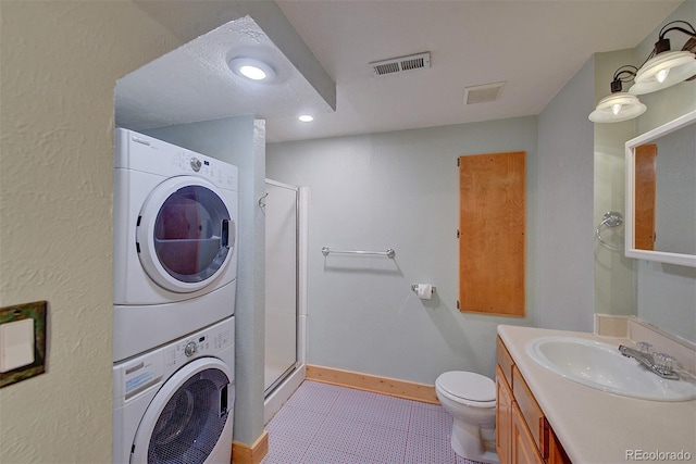 3966 Bosque Ct, Boulder, CO 80301 - full bathroom featuring stacked washing machine and dryer, a shower stall, vanity, toilet, and baseboards