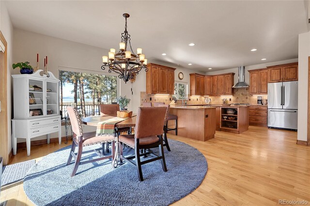 dining room featuring a notable chandelier and light hardwood / wood-style floors