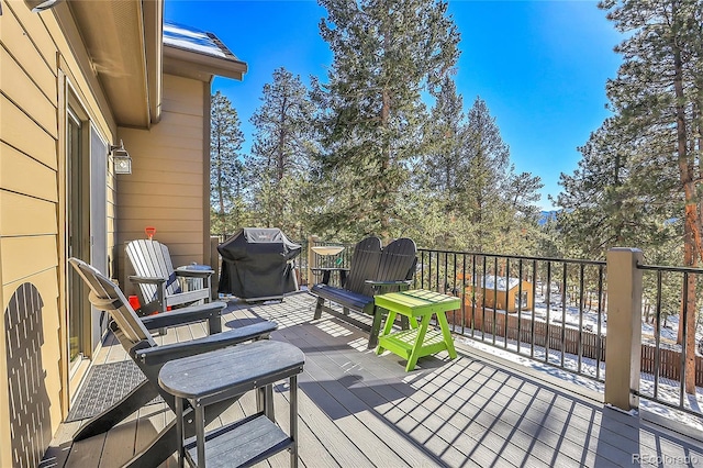 wooden deck featuring a grill