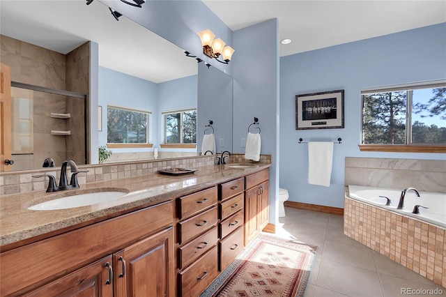 full bathroom with tile patterned flooring, vanity, a healthy amount of sunlight, and toilet