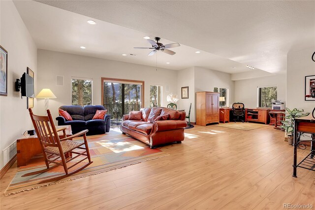 living room with ceiling fan and light wood-type flooring