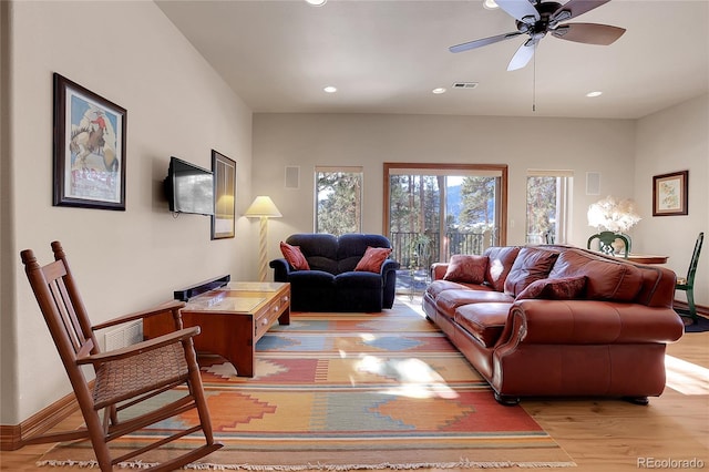 living room with ceiling fan and light wood-type flooring