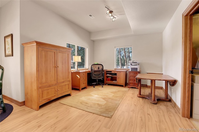 office area with track lighting and light hardwood / wood-style floors