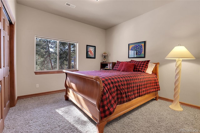 bedroom with light colored carpet and a closet