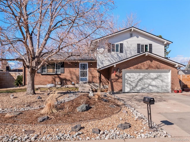 split level home featuring concrete driveway, brick siding, and an attached garage